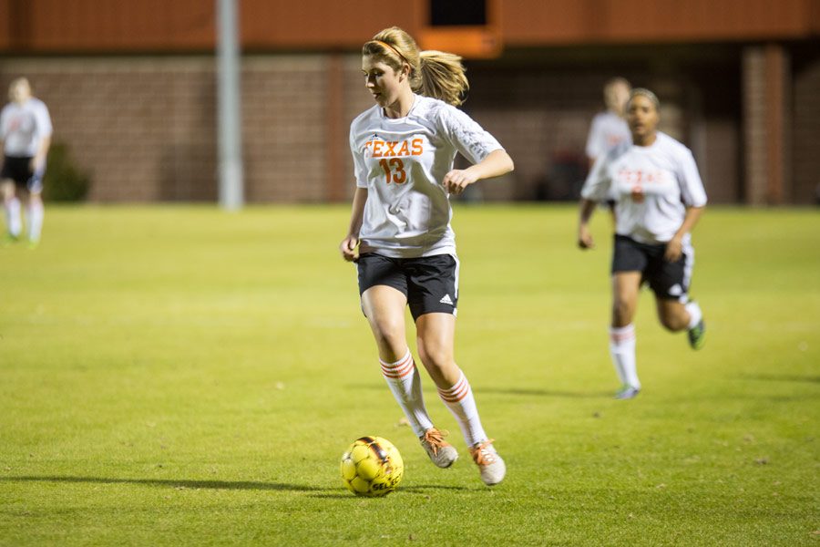 Senior Hannah Brantley dribbles ball down to score.