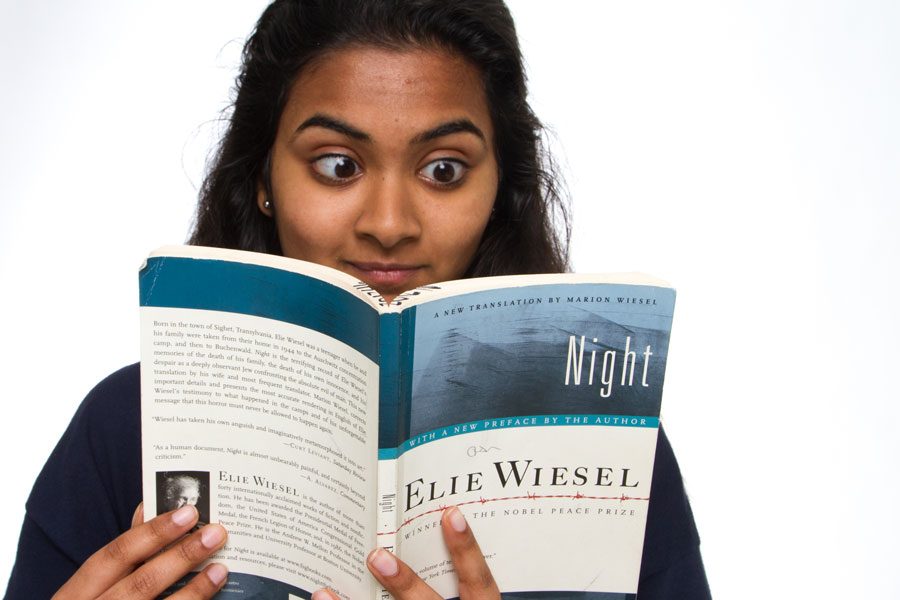Sophomore Raga Justin pictured reading book Night by Elie Wiesel.