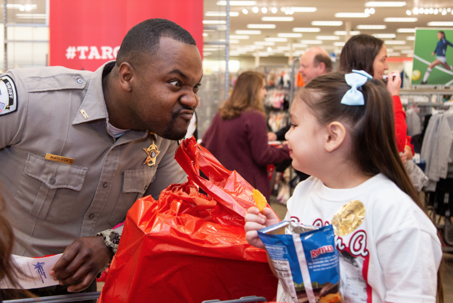 Police officers accompany children at Target as they buy toys. Shop with a Cop was held at Target on Dec. 4.