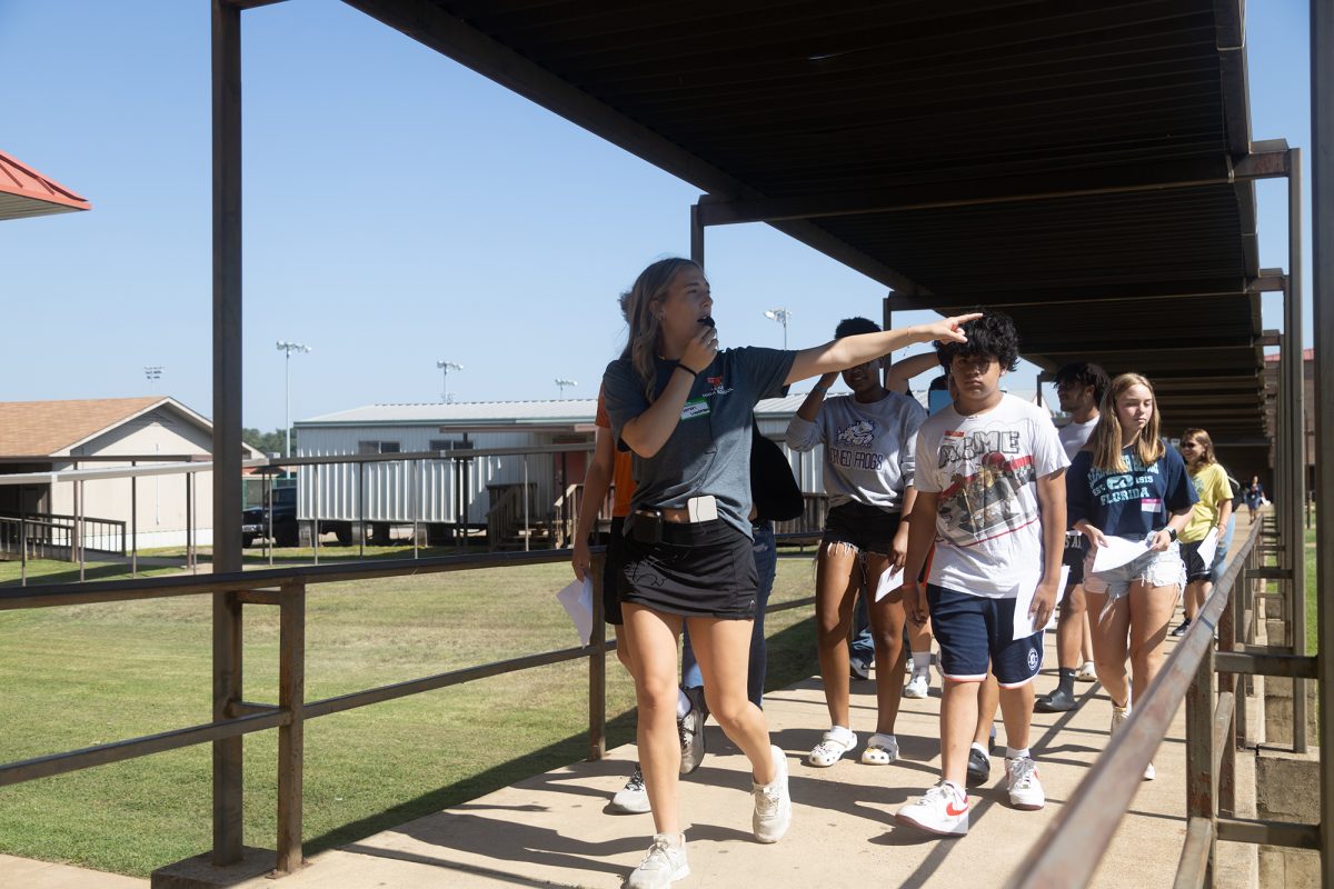 Senior Sarah Woodman guides incoming freshman around the Texas High School campus during the annual Tiger Camp. At the camp, freshman learned traditional school chants, participated in competitive games, given tours and experienced their first pep-rally at Texas High.