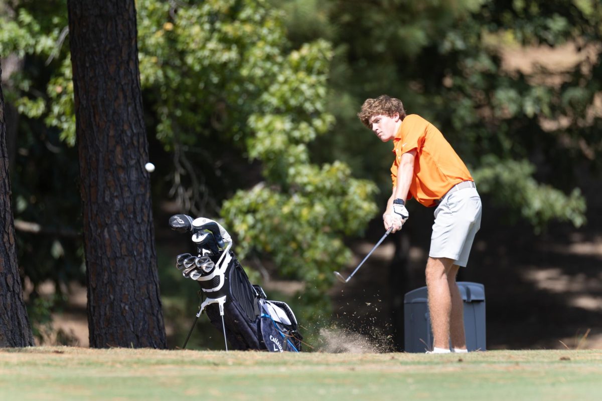 Sophomore Payne Cook chips his ball onto the green during the scrimmage against Pleasant Grove. Texas High Golf scrimmaged the Pleasant Grove Hawks at Northridge Country Club on Aug. 26, 2024.