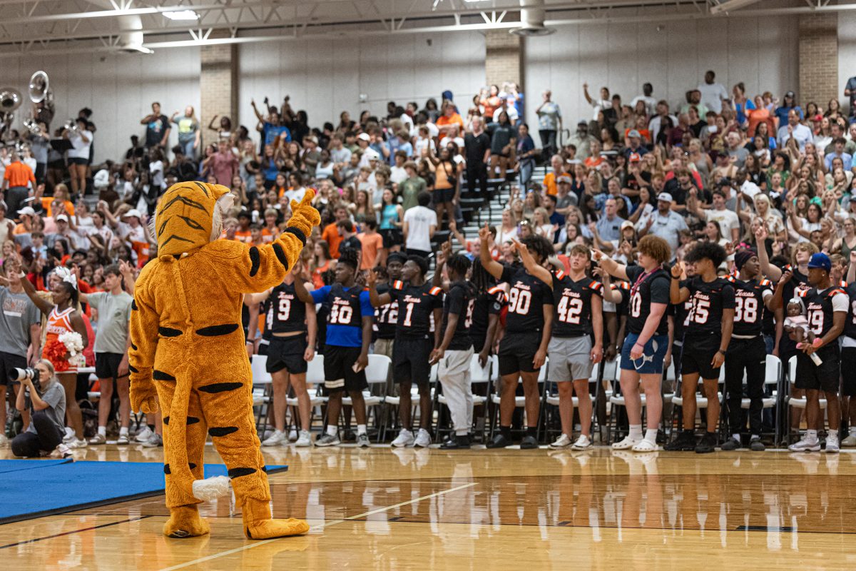 Texas High mascot, Trocia, leads the crowd in the fight song at the annual community pep-rally held in the Tiger Center after the Watermelon Supper on Aug. 5, 2024. Students also picked up schedules and met with teachers before the start of the Watermelon Supper.