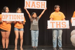 Nash Elementary student Elena Labrada proudly hold her sign representing her school's status as a Leader In Me Lighthouse school at the 2024 TISD Convocation in the Sullivan Performing Arts Center on Aug. 1, 2024.  Labrada serves as a student Lighthouse Team member and Nash Elementary holds the distinction of being first TISD school eligible for Legacy School recognition, the highest honor in Leader In Me schools.