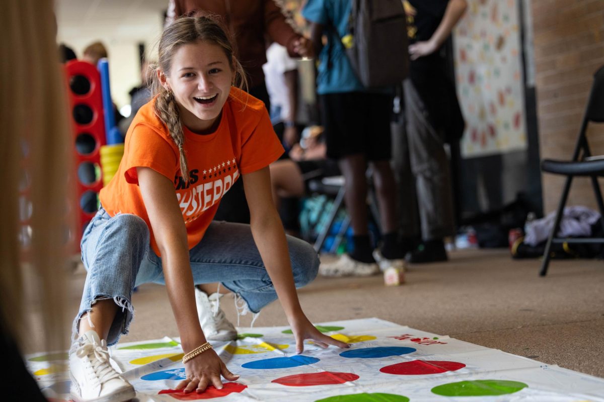 Senior Bella Harrington plays twister at the second annual Leader In Me Luncheon on Sept. 22, 2023. The luncheon featured student-led games for the attendees to participate in. 