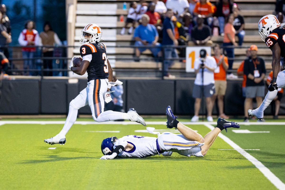 Seen as a Sophomore, Junior Tadarian Ball jumps over opposing team to make a touchtone against the Jacksonville Pirates. 