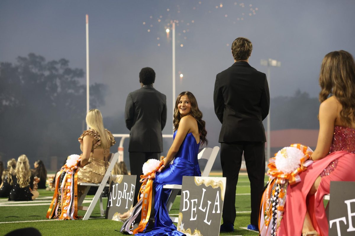 Senior Bella Grace looks back at her friends in amazement at the fireworks show. On Sept. 26, 2024, Texas High held their annual presentation of court ceremony and pep rally at Tiger Stadium at Grim Park. 