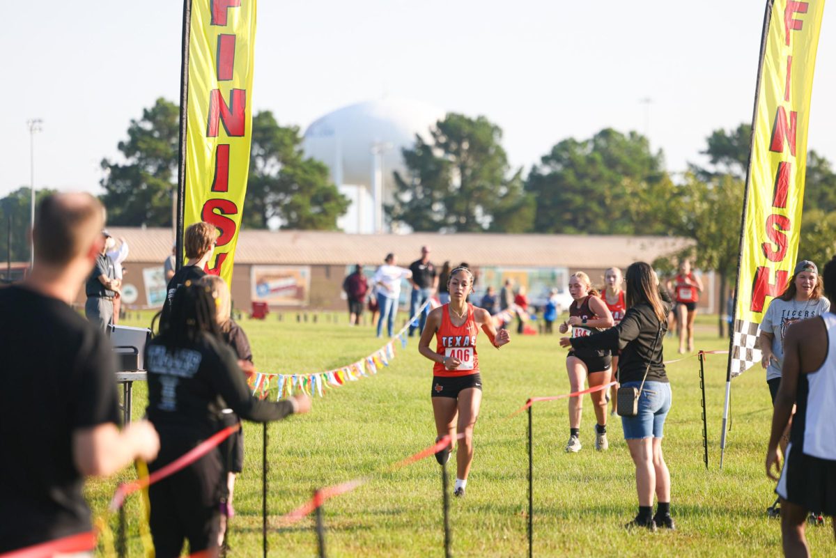 Sophomore Kaelynn Works runs twards the finish line at Texas High's home cross country meet. Works finished second in the varsity girls 5k.