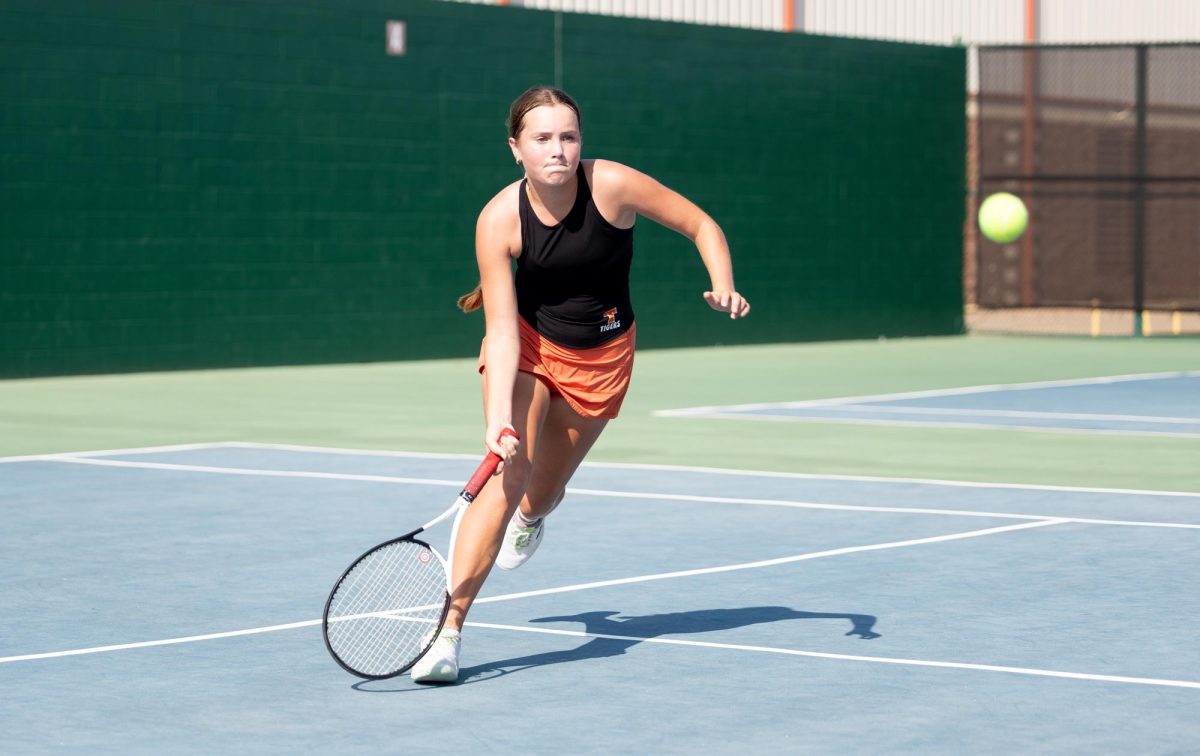 Freshman Sarah Williamson pursues the ball in her match against Pleasant Grove. The Tigers played the Pleasant Grove Hawks on Sep. 20, 2024, the Tigers lost to the Hawks by one match.