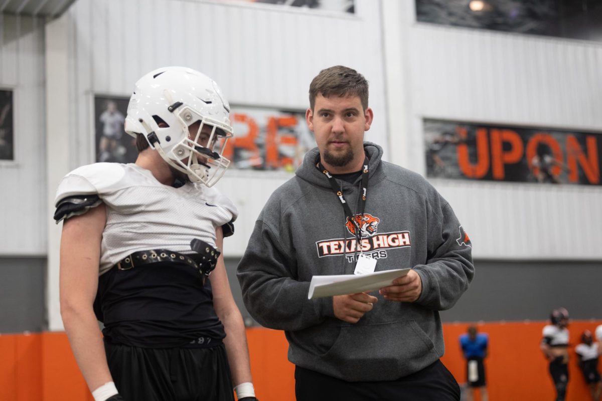 Ryan Forbes coaches player during practice. Forbes, a new history teacher and football coach at Texas high, who transferred here from his previous coaching position, has coached previously for a while now.

