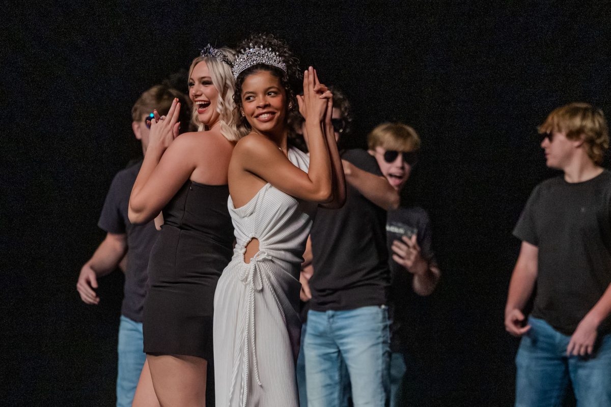 Mary Warren and Cassidy Grant stand back to back in the escort and winners dance during the 2024 Miss THS Pageant.