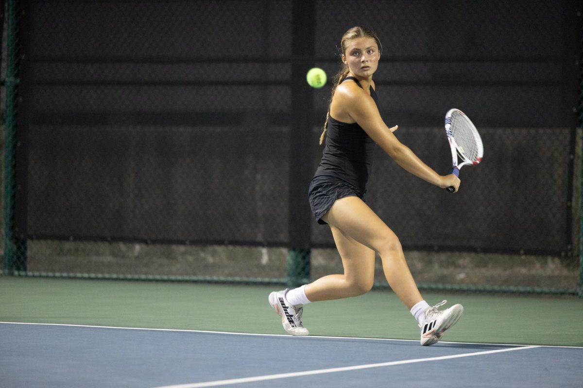 Junior Charlotte Shelton reaches to hit the ball at the Texas High vs. Lufkin tennis tournament on Sept. 24, 2024. Throughout the season, the tennis team pushed through many obstacles, ultimately striving for improvement as it continues. 