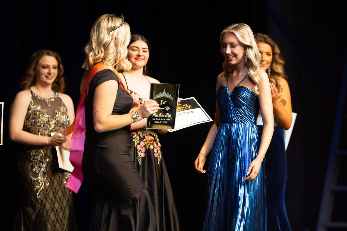 Freshman Olivia Dowd receives award for the 2024 Miss THS Pageant from last year's Talent Winner Mary Warren.