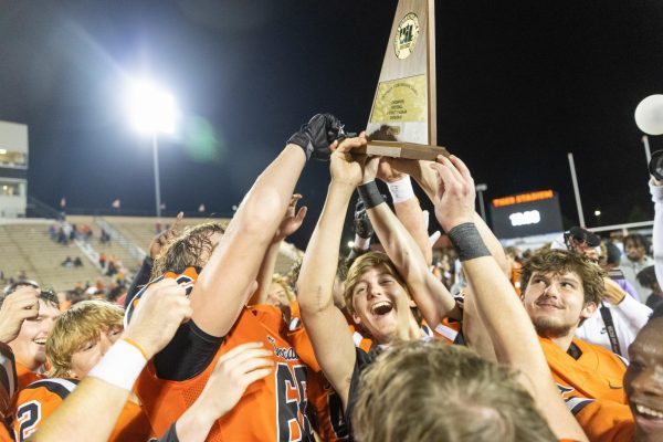 Senior Worth McMillan and his teammates hold up the district champion trophy that the Tigers received after the football game. On Nov. 1, 2024, the Texas Tigers won against the Jacksonville Indians 48-7 and remain undefeated for the season. 