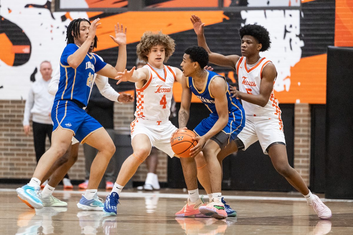 Texas High’s Adam Orr and Justin Brown defend on defense against the Jacksonville Indians on Dec. 17, 2024 in the Tiger Center. The Tigers defeated the Indians 64-61.