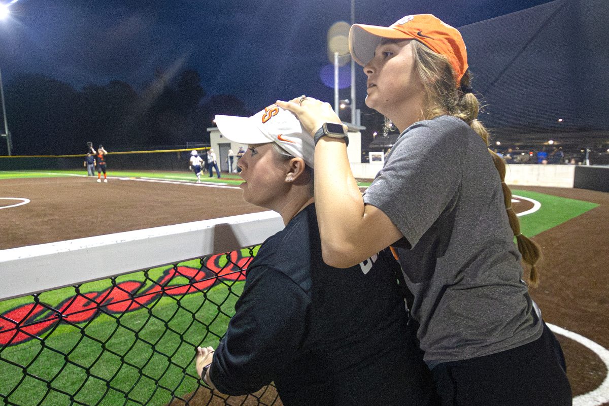 Texas High Head Softball Coach Chelsea Slider grasps the head of Assistant Coach Courtney Cooper as the Lady Tiger Softball Team is one base hit away from win. After the Texas vs. Pine Tree game, the team went onto 5A Division II playoffs.   