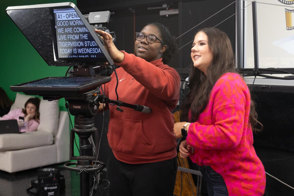 Olivia Coleman helps a student work the teleprompter for the Tigervision show. Coleman returned to Texas High School as a teaching assistant in the Tigervision program, helping adviser and teacher, Charles Aldridge, with audio and video production classes.