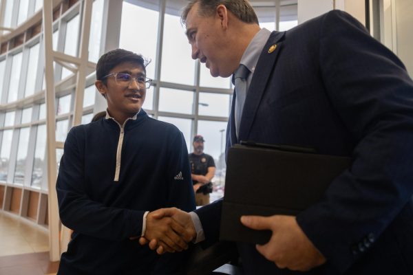 Freshman Nirav Neupane smiles as he shakes Congressman Nathaniel Moran's hand. On Thursday, Jan. 30, Neupane was recognized for winning the Congressional App Award. 