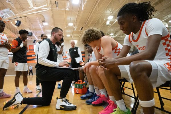 Head Coach Eric Cross huddles with the team to draw and explain defenses. The Tigers played the Tyler Lions Feb. 7, 2025 resulting in a defeat of 59-50.