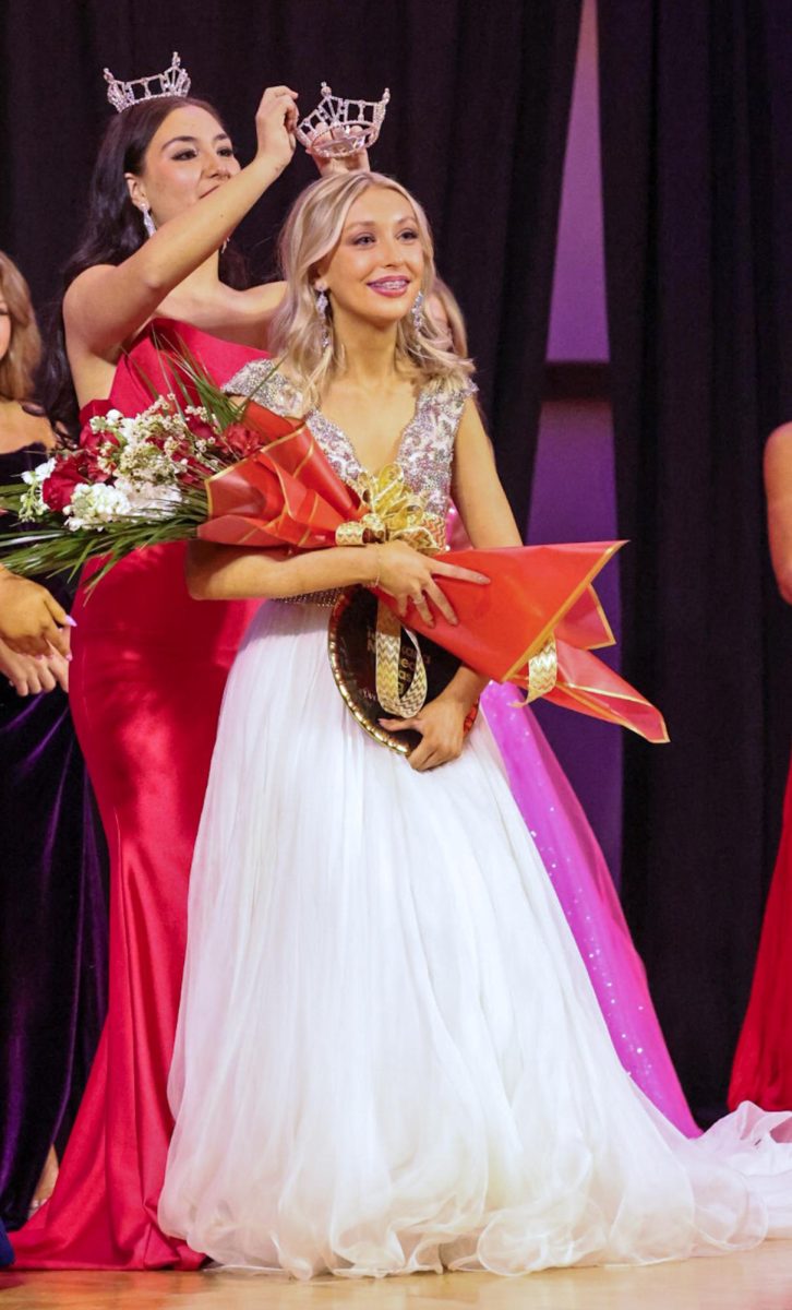 Senior and Miss Twin River's Teen Laila Toubia  crowns freshman Olivia Dowd for the title of Miss Lake O’ The Pines Teen. On Feb. 2, 2025, seven teen contestants competed for the titles of Miss Texarkana, Miss Northeast Texas and Miss Land O' The Pines. 