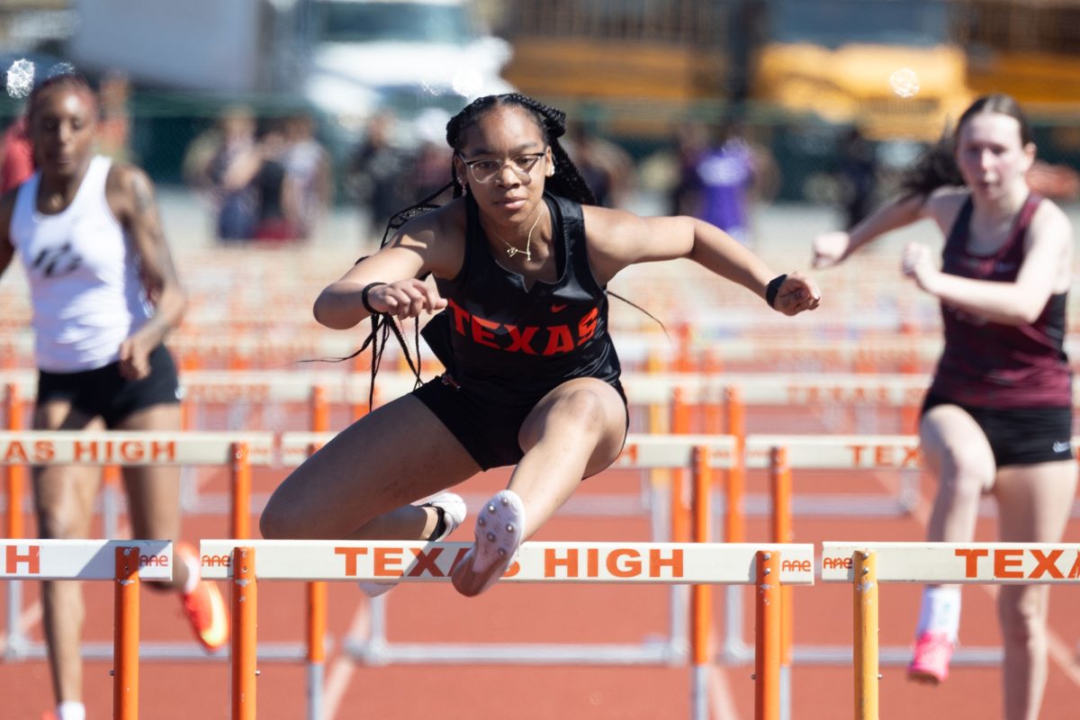 Sophomore Ja'Kiya Moore hurdles in the 100 meter hurdles at the annual Watty Meyers and Kyle Preston Relays, Feb. 28, 2025.