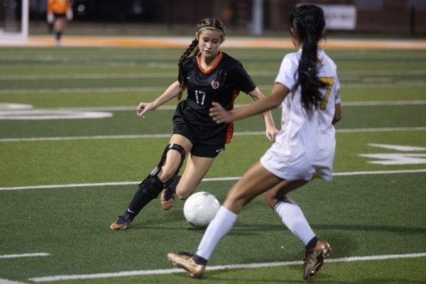 Junior soccer team captain Alexis West prepares to kick the ball during the Tigers' game against Nacadoches on Feb. 11, 2025. Throughout the course of her high school career, West injured her anterior cruciate ligament (ACL), medial collateral ligament (MCL) and meniscus, benching her for most of the year.