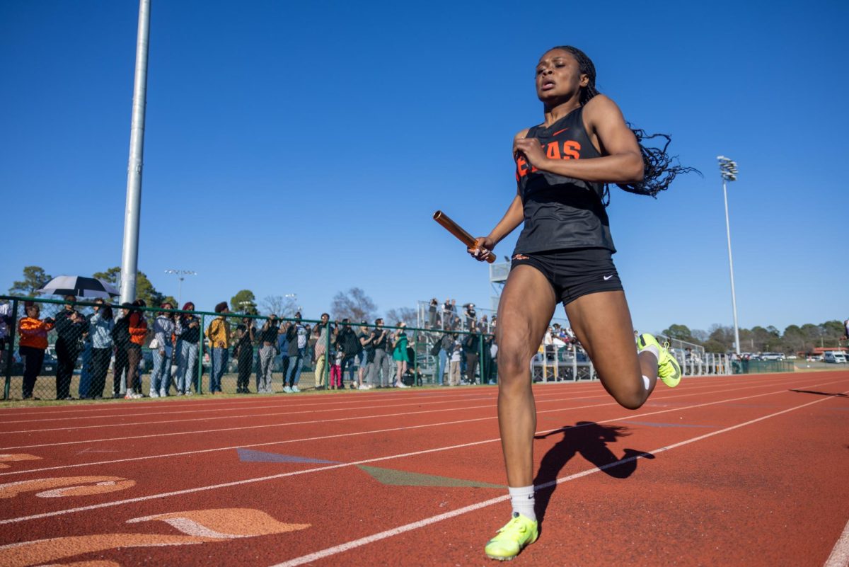 Junior Deja Aubrey cross the finish line after the 4 times 100 meter relay at the annual Watty Meyers and Kyle Preston Relays Feb. 28, 2025. Aubrey won 17 points for the Texas High JV girls allowing them to win first place at the meet.